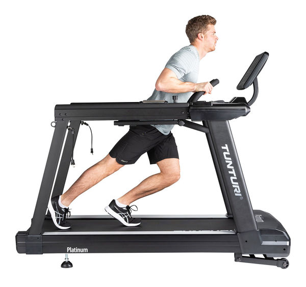 WWhite background image of a model using the sled function of the Tunturi Platinum Core Treadmill.