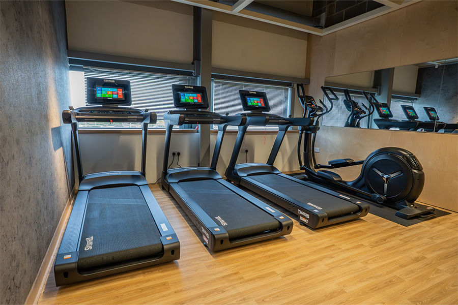 A photograph of the three Taurus T10.3HD Pro Smart Treadmills and the Taurus X190.5 Pro Real Wheel Elliptical.