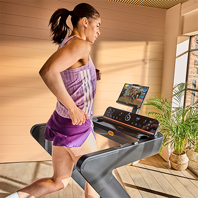 Model running on adidas T-700 Treadmill with interactive training app 