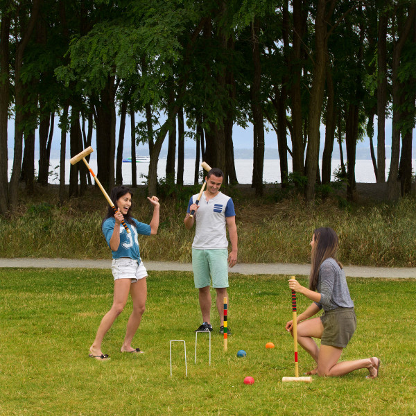 Group of people celebrating during a croquet game.
