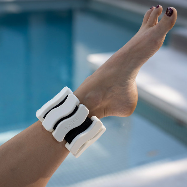 A close-up image of the BAHE Silicone Ankle and Wrist Weights on a model's ankle.
