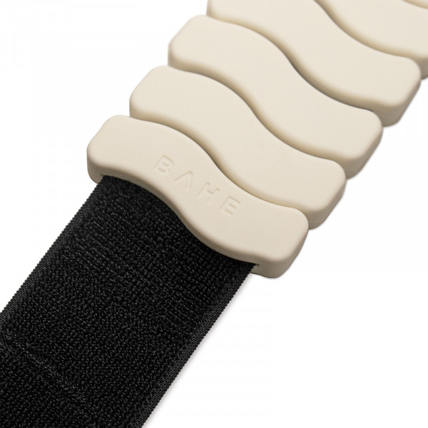 A close-up white background image of the BAHE Silicone Ankle and Wrist Weights in Coconut colour, the focus is on the strap showing that the strap lays flat.