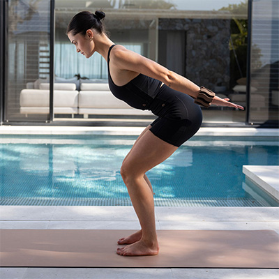 Photograph of a model squatting on the BAHE Studio Stance 5mm Mat