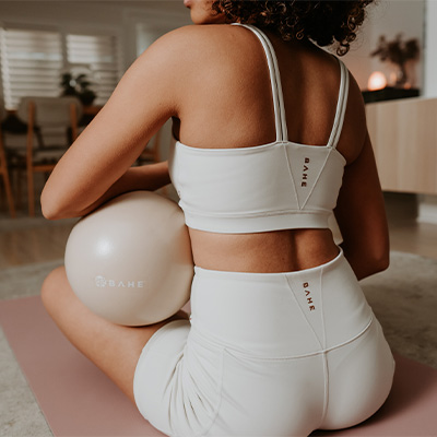 Lifestyle image of a model sitting with the BAHE Flowball