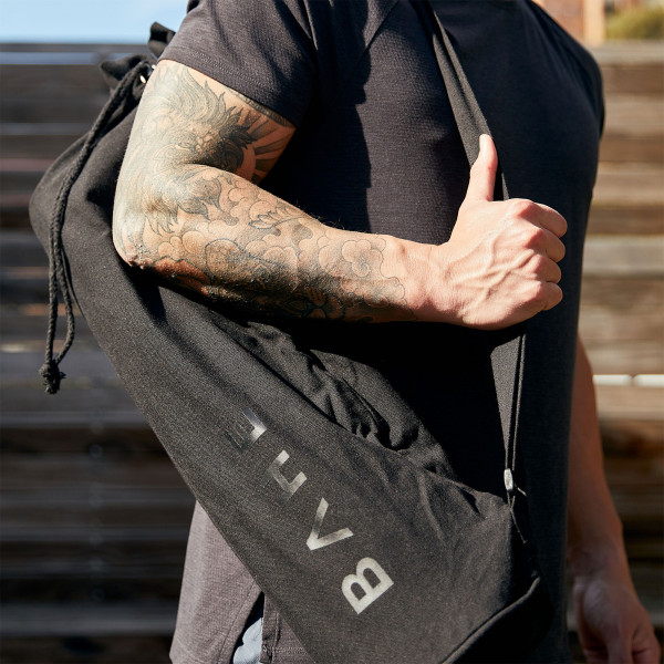 Close up lifestyle image of the BAHE Essential Yoga mat bag being worn by a model