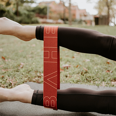 Image of a model using the medium BAHE Flowloop to perform an abductor stretch.