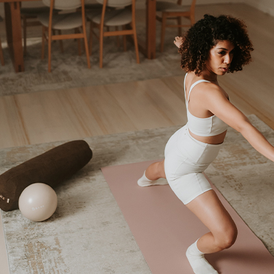 Lifestyle image of a model performing yoga on the BAHE Soft Touch 5mm Mat 