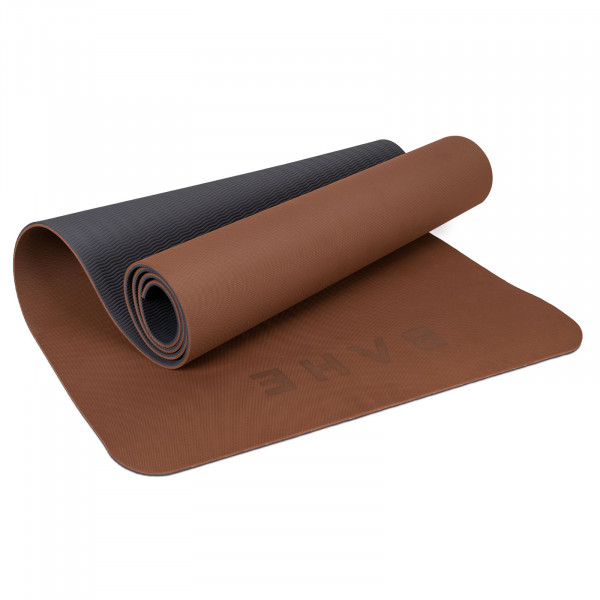 A product image showing the BAHE Soft Touch Reversible XL 6mm Mat partially rolled displaying both sides in the Cinnamon colour variation.