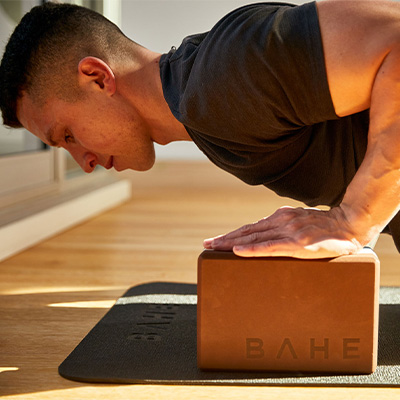 Photograph of a model performing a Plank on the BAHE Yoga Block