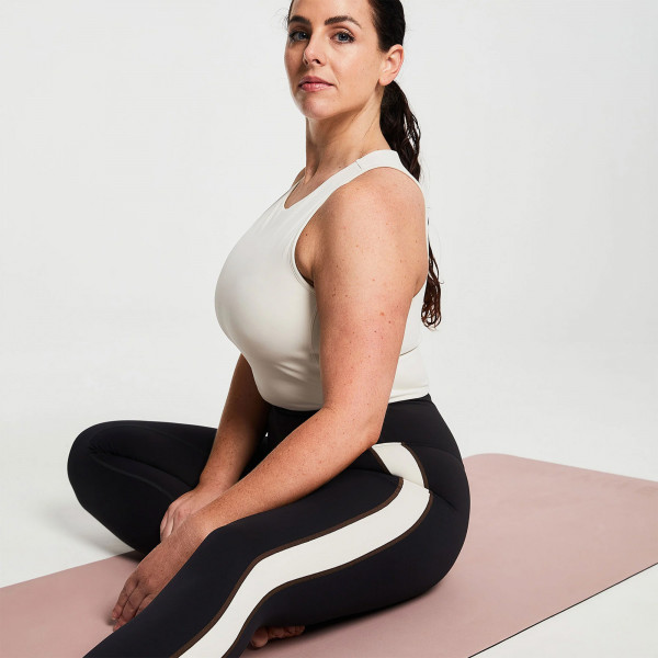 Lifestyle image of a model sitting on the BAHE Soft Touch Pro 5mm Mat.