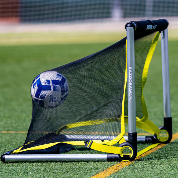 Close-up of the BazookaGoal Football Goal (Aluminium), Silver / Black, ball hitting net on grass pitch