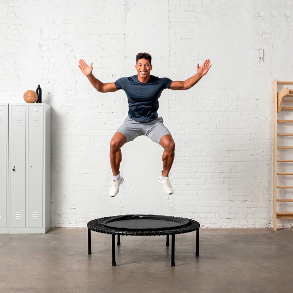 Person using bellicon Classic Black Trampoline for balance training.
