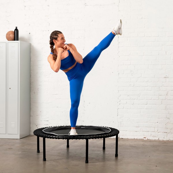 Person using Bellicon Classic Black Trampoline for cardio exercise.
