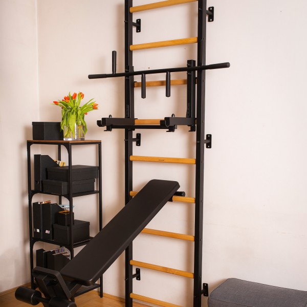 BenchK Pull Up Bar PB3B Black - a ladder with a pull-up bar attached for exercise in a home gym setup