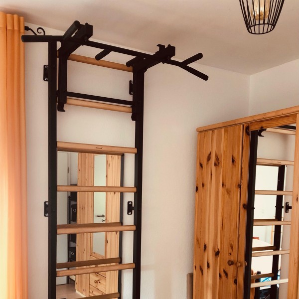 BenchK Pull Up Bar PB3B Black - a ladder with a pull-up bar attached for exercise in the corridor