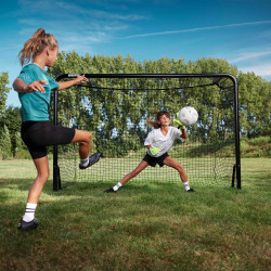 One player shooting while another saves the ball at the BERG SportsGoal.
