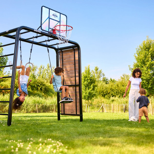 Kids playing under the BERG PlayBase with a basketball hoop