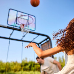 Close-up of child throwing basketball at the BERG PlayBase hoop