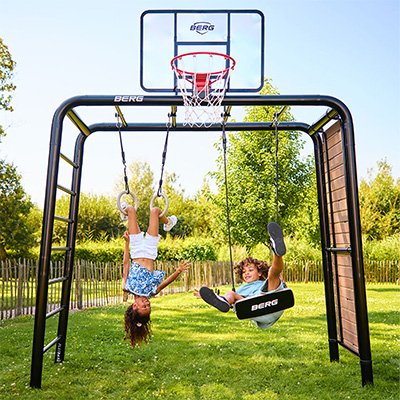 Kids swinging and hanging upside down on the BERG PlayBase