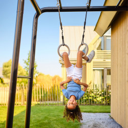 Child hanging upside down on the BERG PlayBase Gym Rings