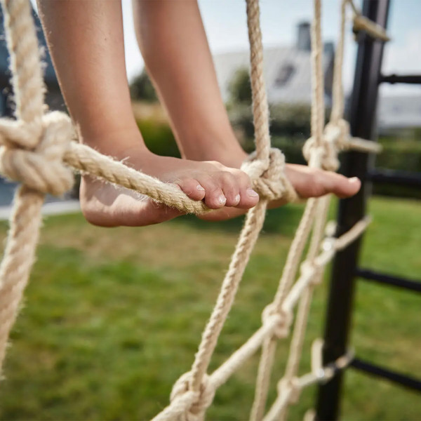 Bare feet balancing on BERG PlayBase Climbing Net ropes