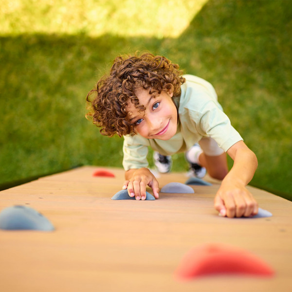 Child climbing up the BERG PlayBase Climbing Wall