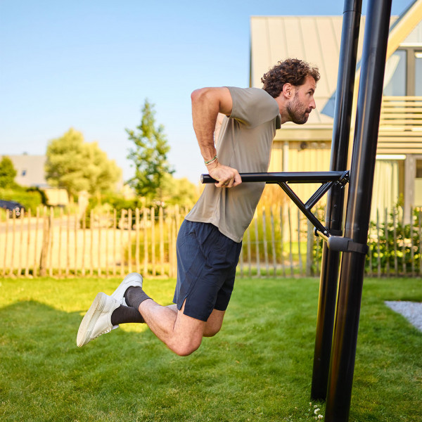 Model performing dip exercise on the BERG PlayBase Dip Bar