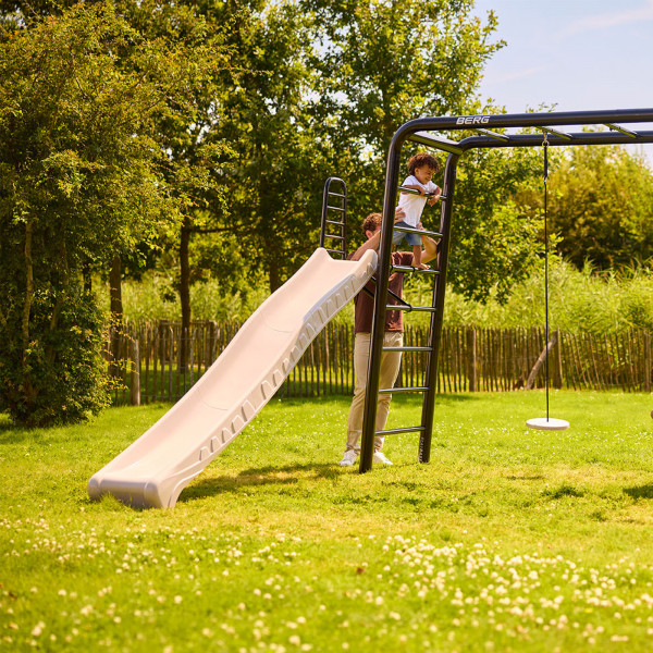 Toddler climbing ladder to use the BERG PlayBase Slide