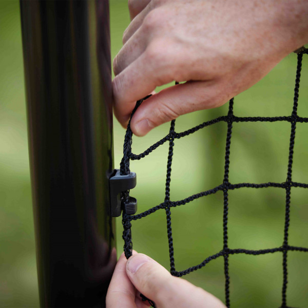 Hand securing the BERG SportsGoal net to the frame.
