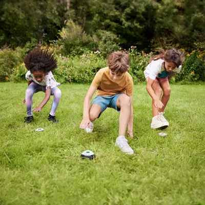 Models playing with the BERG Infinity Pods Set 6 on grass 