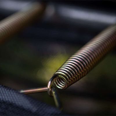 Close-up of a metal spring on the BERG Sports Favorit Inground Trampoline