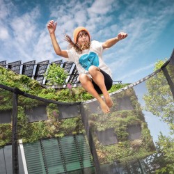 A child having fun on the BERG Favorit InGround 330 Trampoline With Safety Net Comfort.
