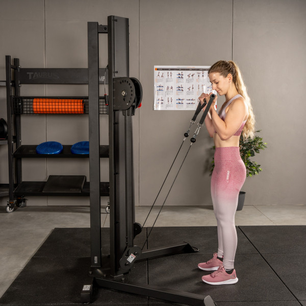 Person setting up for a cable curl on the BodyCraft EFT Functional Trainer.