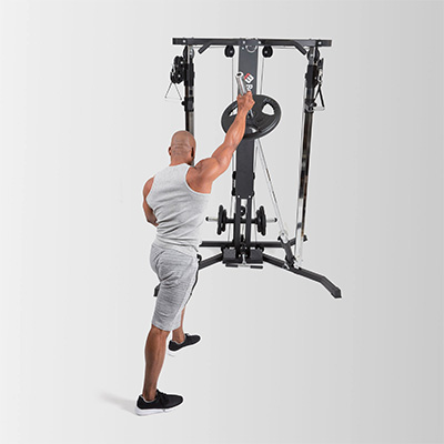 Model performing single arm landmine press on the BodyMax Cable Motion Rack System