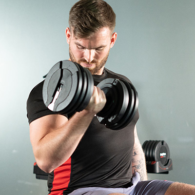 User performing curl with the BodyMax 25 kg Selectabell Adjustable Dumbbell
