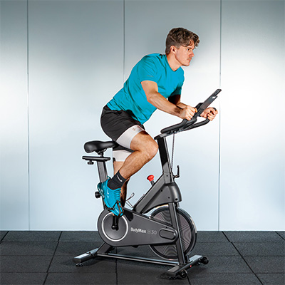 A model standing to cycle on the BodyMax SC30