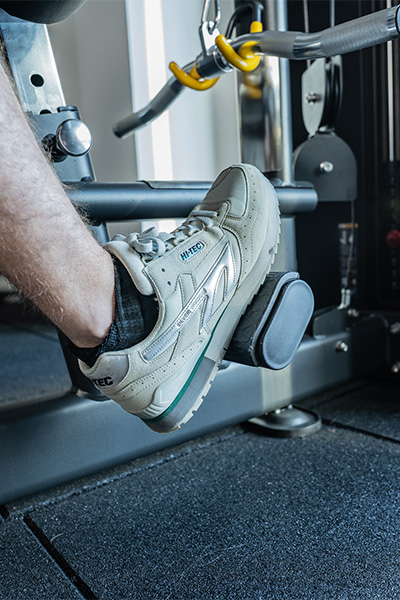 close-up of user foot on gym machine with 40mm floor tiles