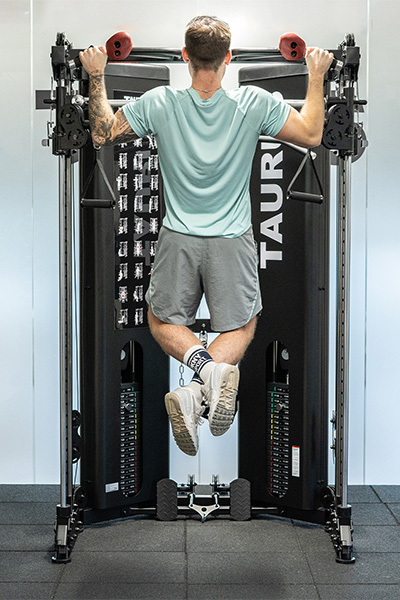 user doing pull-ups on cable machine with 40mm floor tiles