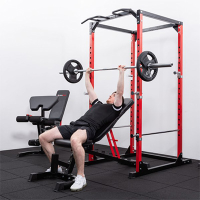User bench pressing inside the BodyMax CF375 Power Rack