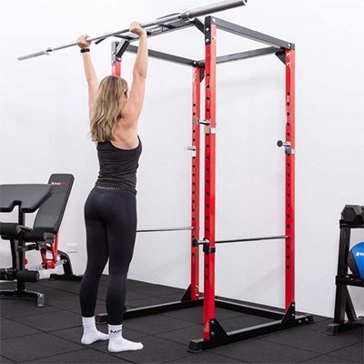 User pressing overhead in the BodyMax CF375 Power Rack