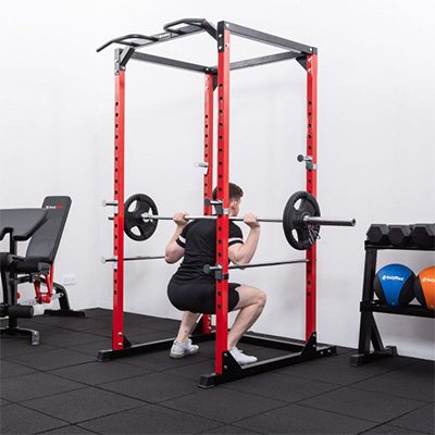 User squatting with a loaded barbell inside the BodyMax CF375 Power Rack