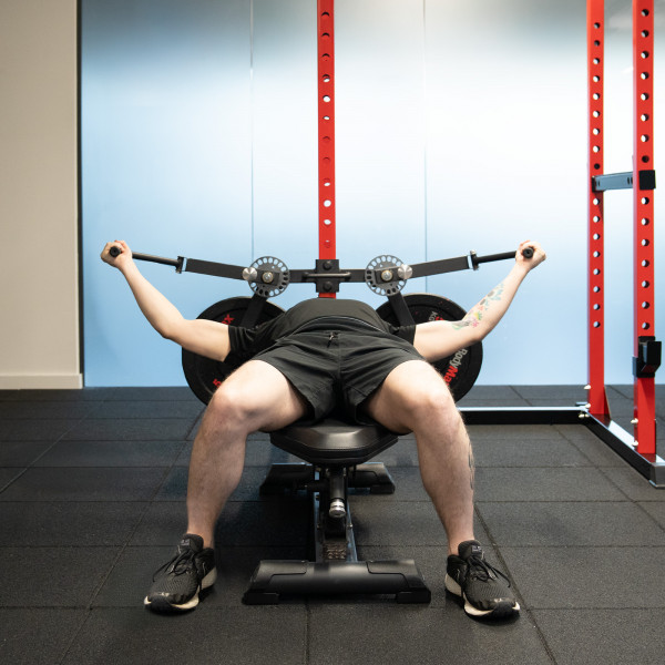 Lifestyle image of the Bodymax Rack Fly Attachment with a model using a bench