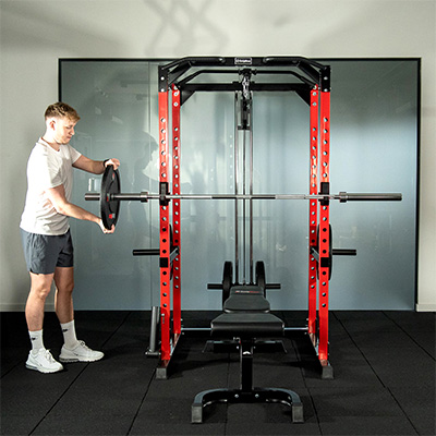 Lifestyle image of a model loading a barbell on the BodyMax CF475