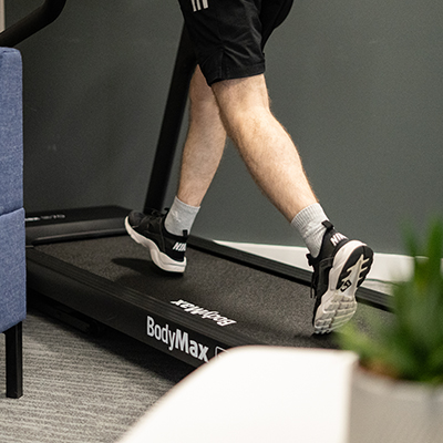 Close-up of user’s feet on the BodyMax TM70 treadmill belt