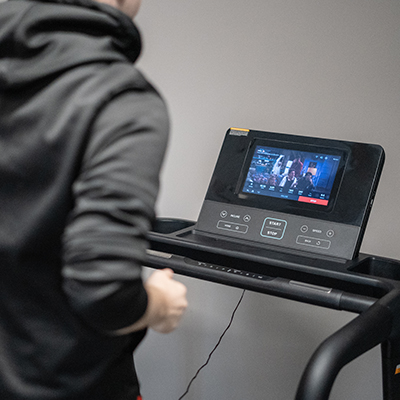 User running on the BodyMax TM70 treadmill with screen on