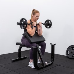 User curling a barbell on the BodyMax CF625 Preacher Curl Bench