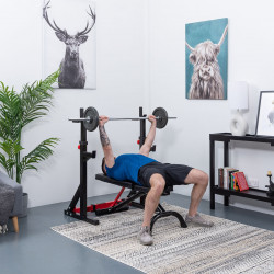 User bench pressing at full extension with the BodyMax CF325 FID Utility Weight Bench