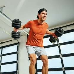BowFlex 52s Adjustable Dumbbell - Model performing rear delt flies