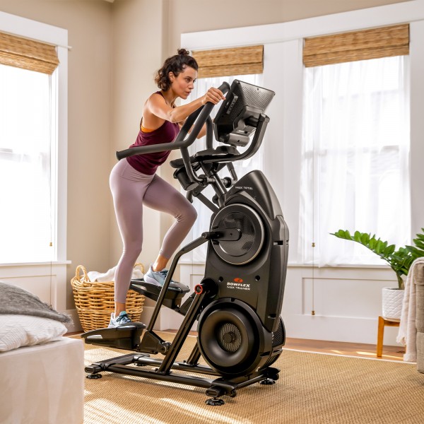 A user experiencing a high-intensity workout on the BowFlex Max Total 40, illustrating the user's dedication and the machine's durability