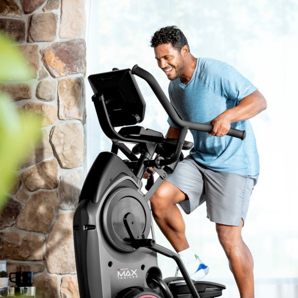 An exerciser customising their workout routine on the BowFlex Max Trainer M9